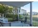 Relaxing outdoor patio with chairs, table, and scenic community views at 204 Michigan Ave # C-5 - 11, Folly Beach, SC 29439
