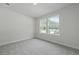 Bedroom featuring neutral walls, soft carpet, and natural light from two windows for a calming atmosphere at 205 Somerset Acres Dr, Summerville, SC 29486