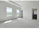 A bright bedroom with plush gray carpet and an ensuite bath with a door to close it off at 205 Somerset Acres Dr, Summerville, SC 29486