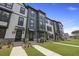 Three-story townhome with a well-maintained lawn and landscaped front yard at 205 Somerset Acres Dr, Summerville, SC 29486
