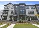 Modern townhome featuring a manicured lawn and stylish architectural details at 205 Somerset Acres Dr, Summerville, SC 29486