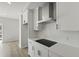 Bright kitchen with white cabinetry, stainless steel range hood, modern backsplash, and black cooktop at 205 Somerset Acres Dr, Summerville, SC 29486