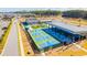 Aerial view of community pickleball courts, lounge, and bar area with covered seating and lush landscaping near a pond at 205 Somerset Acres Dr, Summerville, SC 29486