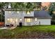 Rear exterior view featuring a patio with seating, a well-maintained lawn, and painted brick at 205 Towhee Dr, Summerville, SC 29485
