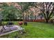 Spacious backyard featuring a patio area with outdoor seating, a lush lawn, and mature trees for shade at 205 Towhee Dr, Summerville, SC 29485