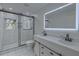 Modern bathroom featuring a sleek glass-enclosed shower, double vanity with stylish mirrors, and elegant fixtures at 205 Towhee Dr, Summerville, SC 29485