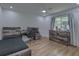 Charming bedroom featuring hardwood floors, a gaming setup, and modern decor at 205 Towhee Dr, Summerville, SC 29485