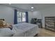 Inviting bedroom featuring a comfortable bed, hardwood floors, and a window with blue curtains at 205 Towhee Dr, Summerville, SC 29485