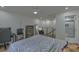 Comfortable bedroom featuring hardwood floors, a gaming setup, and an attached bathroom at 205 Towhee Dr, Summerville, SC 29485