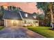 Inviting home featuring a three-car garage, a welcoming front porch, and a well-manicured lawn at 205 Towhee Dr, Summerville, SC 29485
