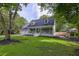 Charming two-story home with a well-manicured lawn, dormer windows, and inviting front porch at 205 Towhee Dr, Summerville, SC 29485