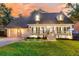 Charming two-story home featuring a welcoming front porch, well-manicured lawn, and attached two-car garage at 205 Towhee Dr, Summerville, SC 29485