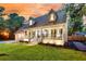 Charming two-story home boasts a welcoming front porch, lush lawn, and inviting curb appeal with dormer windows at 205 Towhee Dr, Summerville, SC 29485