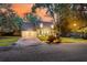Charming two-story home featuring a welcoming front porch and attached two-car garage with large trees at 205 Towhee Dr, Summerville, SC 29485