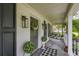 Charming front porch featuring stylish decor, a black and white checkered rug, and welcoming ambiance at 205 Towhee Dr, Summerville, SC 29485