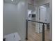Bright open hallway featuring modern railings with a view of living area, natural light and neutral color palette at 205 Towhee Dr, Summerville, SC 29485