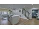 Open concept living area with kitchen island and breakfast nook leading to stairway and second living area at 205 Towhee Dr, Summerville, SC 29485