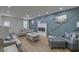 Stylish living room with a fireplace, modern furniture, hardwood floors, and a decorative accent wall at 205 Towhee Dr, Summerville, SC 29485