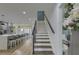 Open concept shows staircase with wood treads and white risers, ascending from the updated kitchen into other rooms at 205 Towhee Dr, Summerville, SC 29485