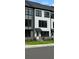 Modern townhome with white siding, black trim, and a welcoming front entrance at 209 Somerset Acres Dr, Summerville, SC 29486