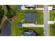 An aerial shot of a home with a dark roof, surrounded by well-maintained greenery, and a long driveway at 2408 Bent Oak Rd, Mount Pleasant, SC 29466