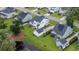 Aerial view of homes with well-kept lawns, mature trees, and a scenic pond in a Gathering-friendly neighborhood at 2408 Bent Oak Rd, Mount Pleasant, SC 29466