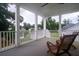 Back porch featuring white columns and wooden chairs with a nice backyard view at 2408 Bent Oak Rd, Mount Pleasant, SC 29466