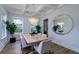 Elegant dining room with a large round mirror, statement chandelier, and view of the backyard at 2408 Bent Oak Rd, Mount Pleasant, SC 29466