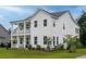 Charming two-story white home with a covered front porch and manicured lawn at 2408 Bent Oak Rd, Mount Pleasant, SC 29466