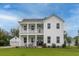 Charming two-story home boasting a double front porch, well-manicured lawn, and attached garages at 2408 Bent Oak Rd, Mount Pleasant, SC 29466