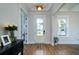 Bright foyer with hardwood floors, elegant lighting, and a view of the manicured front yard at 2408 Bent Oak Rd, Mount Pleasant, SC 29466