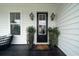 Inviting entryway featuring stylish lanterns, a modern black door, and tasteful potted plants at 2408 Bent Oak Rd, Mount Pleasant, SC 29466