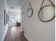 Hallway features wood flooring, mirrors and a door leading to the front porch at 2408 Bent Oak Rd, Mount Pleasant, SC 29466