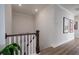 Hallway featuring a staircase, hardwood floors, and framed wall art at 2408 Bent Oak Rd, Mount Pleasant, SC 29466