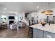 Open-concept living room featuring hardwood floors, a fireplace, and seamless flow into the kitchen at 2408 Bent Oak Rd, Mount Pleasant, SC 29466