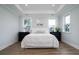 Bright primary bedroom with tray ceiling, hardwood floors, and two large windows at 2408 Bent Oak Rd, Mount Pleasant, SC 29466