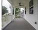 Spacious porch with white railing and ceiling fan; perfect for relaxing outdoors at 2408 Bent Oak Rd, Mount Pleasant, SC 29466