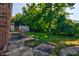 A spacious backyard with mature trees and a storage shed offers a private outdoor space at 2657 Oregon Ave, North Charleston, SC 29405