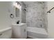 Bathroom features a vanity sink, toilet, and a bathtub with beautifully tiled walls at 2657 Oregon Ave, North Charleston, SC 29405