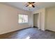 This bedroom features a ceiling fan, large window, and closet at 2657 Oregon Ave, North Charleston, SC 29405