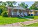Charming brick home with a inviting front porch and a well-manicured lawn at 2657 Oregon Ave, North Charleston, SC 29405