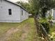 Side view of a light blue house with a grassy and dirt yard at 2749 E Surrey Dr, North Charleston, SC 29405