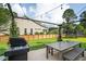 Backyard with a dining table, grill, privacy fence, and ambient string lights at 2828 Wagner Way, Mount Pleasant, SC 29466