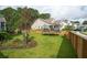 Backyard featuring a lush green lawn, a trampoline, and a wooden fence for added privacy at 2828 Wagner Way, Mount Pleasant, SC 29466
