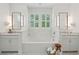 Elegant bathroom featuring a soaking tub, double sinks, and white marble tiling at 2828 Wagner Way, Mount Pleasant, SC 29466