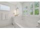 Relaxing bathroom with a soaking tub, natural light, and stylish tiling at 2828 Wagner Way, Mount Pleasant, SC 29466