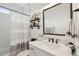 Charming bathroom with a subway tile shower, decorative shelves, and a white vanity at 2828 Wagner Way, Mount Pleasant, SC 29466