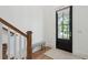 Bright foyer features wood floors, staircase, bench, and black front door at 2828 Wagner Way, Mount Pleasant, SC 29466