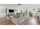 Bright living room with large sectional sofa, hardwood floors, and surf themed décor at 2828 Wagner Way, Mount Pleasant, SC 29466