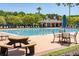 Community pool area with lounge chairs, picnic tables, shady umbrellas, and a covered grilling area at 2828 Wagner Way, Mount Pleasant, SC 29466